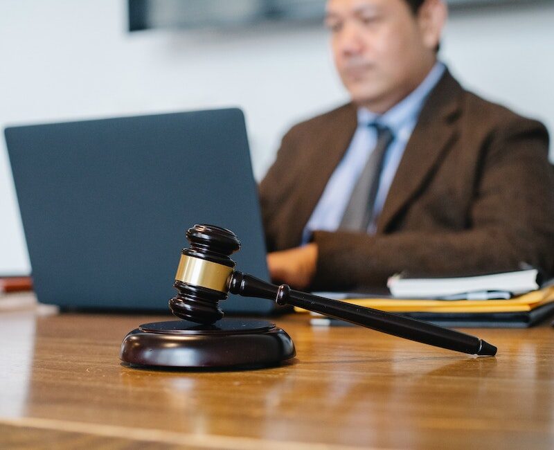 Asian judge working on laptop in office